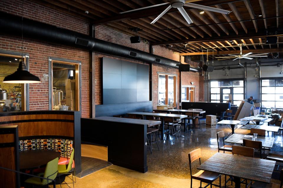 The 9-foot TV screen on the left wall inside Yee-Haw Brewing Co. at 745 N. Broadway actually is nine screens in one, allowing employees to show one game across the entire surface or multiple programs at once. A long "catwalk" bar, not pictured, faces the screens and is carved from a single tree.