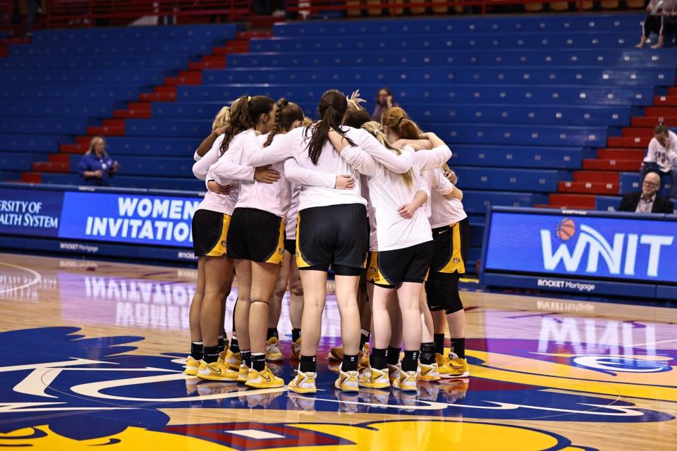 The Missouri women's basketball team huddles at center court before its WNIT game against Kansas on March 20, 2023, at the Allen Fieldhouse in Lawrence, Kansas.