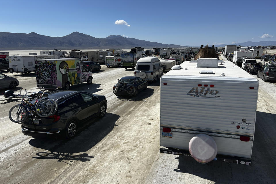 Vehicles line up to leave the Burning Man festival in Black Rock Desert, Nev., Tuesday, Sept. 5, 2023. The traffic jam leaving the festival eased up considerably Tuesday as the exodus from the mud-caked Nevada desert entered a second day following massive rain that left tens of thousands of partygoers stranded there for days.(Monique Sady via AP)