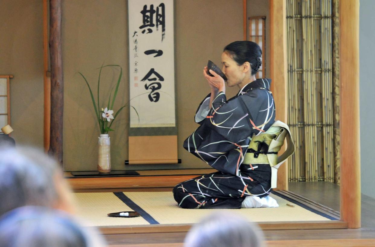 Megumu Mabuchi, of Urasenke Boston, drinks tea during a Japanese tea ceremony at The Art Complex Museum in Duxbury, Sunday, July 31, 2022.
