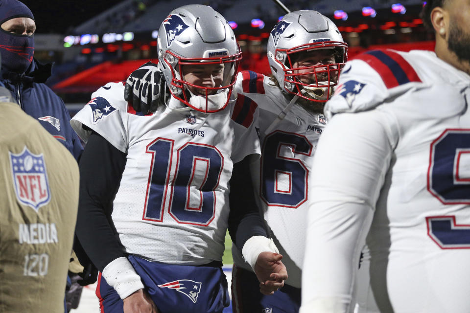 New England Patriots quarterback Mac Jones (10) and David Andrews (60) walk off the field after getting a win over the Buffalo Bills in an NFL football game in Orchard Park, N.Y., Monday, Dec. 6, 2021. (AP Photo/Joshua Bessex )