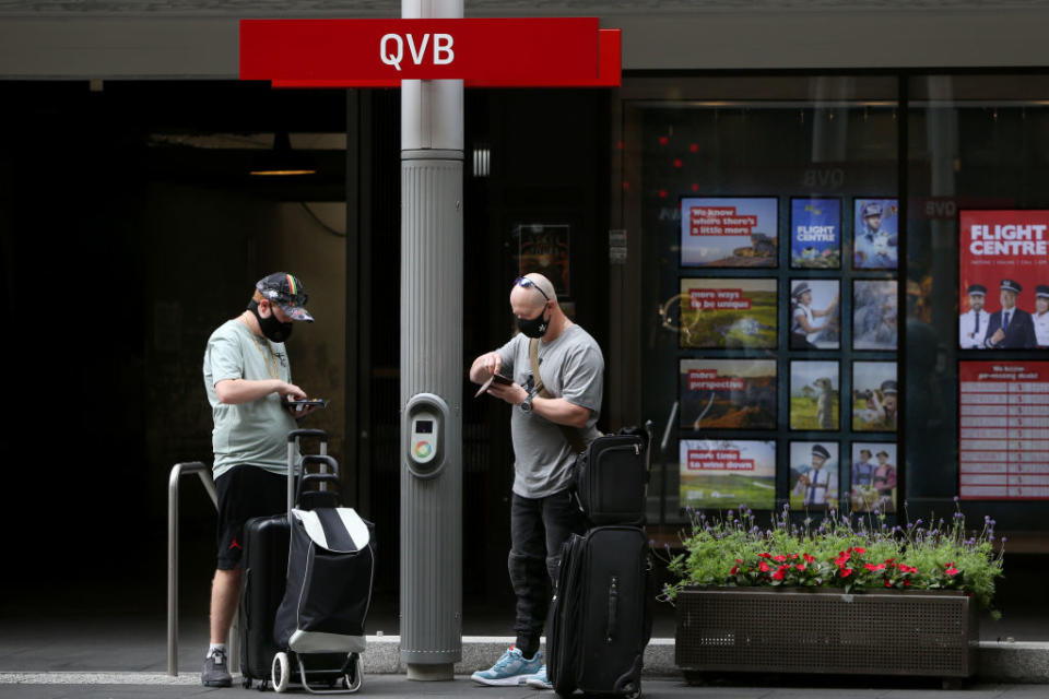 People queue to catch a tram outside the QVB in Sydney, Australia. COVID-19 restrictions have eased further today for fully vaccinated people in New South Wales as the state continues to record high vaccination rates.