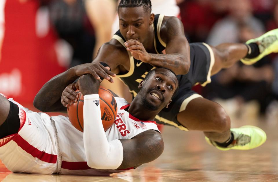 Nebraska's Juwan Gary calls for a timeout after grabbing a loose ball next to Purdue's Lance Jones.