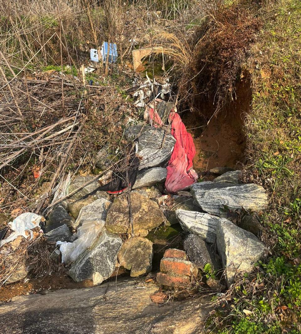 Blankets, and personal trash are stretched throughout a creek leading to the Chattahoochee River and the riverwalk. 2/3/24