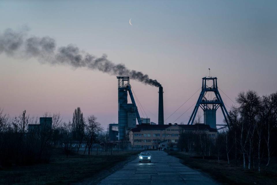 FILE - The Stepova coal mine just before dawn in Pershotravensk, Dnipropetrovsk region, eastern Ukraine, Monday, April 1, 2019. (AP Photo/Evgeniy Maloletka, File)