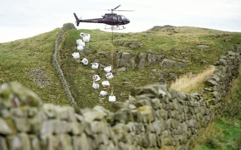 In October the National Trust were forced to fly in 35 tonnes of stone by helicopter to repair a 250ft section at Caw Gap - Credit: North News & Pictures