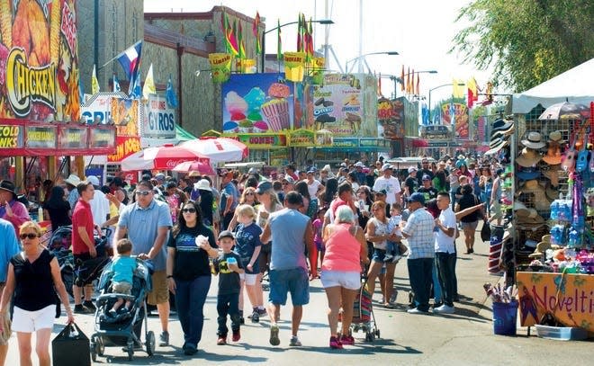 Crowds gather around vendor stands at the Colorado State Fairgrounds during the 2017 state fair.