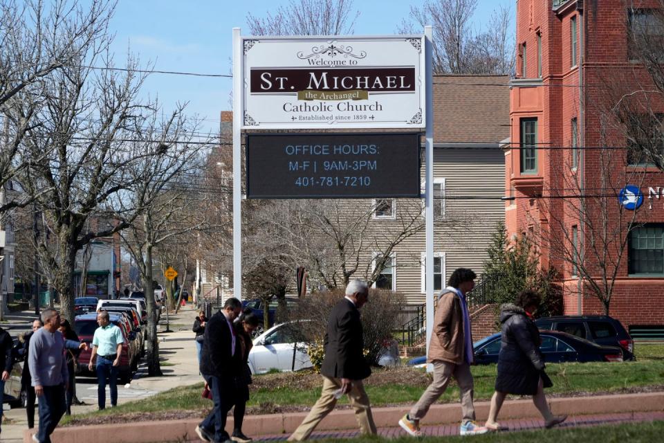 Parishioners head into St. Michael's for Mass on Palm Sunday.