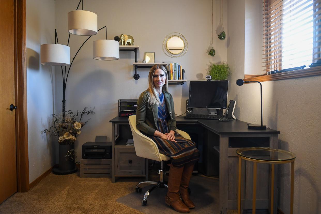 Caminando Juntos educational coordinator April Ross poses inside her home office on Thursday, Dec. 22, 2023 in Sioux Falls.