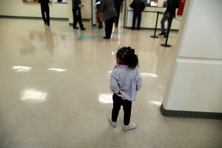 A girl waits with visitors in the lobby of the Adelanto immigration detention center, which is run by the Geo Group Inc (GEO.N), in Adelanto, California, U.S., April 13, 2017. REUTERS/Lucy Nicholson