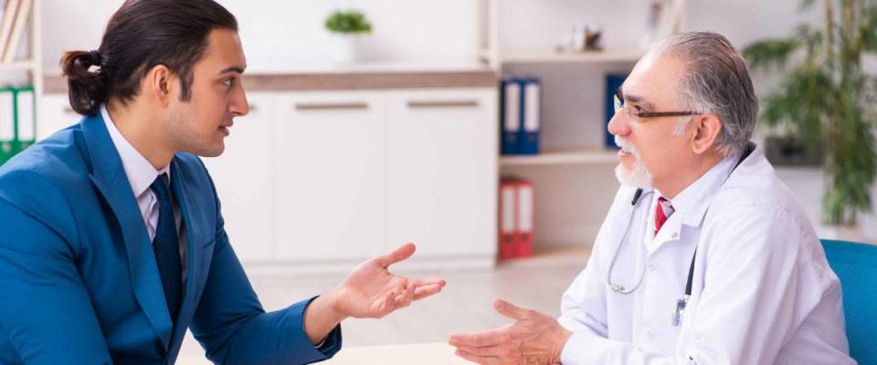 Young businessman meeting with old doctor