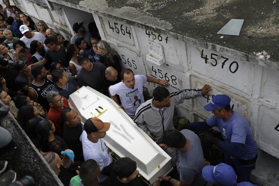 People carry the coffin of 8-year-old Ágatha Sales Felix, who was hit by a a stray bullet, at a cemetery in Rio de Janeiro, Brazil, Sunday, Sept. 22, 2019. Félix was hit by a stray bullet Friday amid what police said was shootout with suspected criminals. However, residents say there was no shootout, and blame police. (AP Photo/Silvia Izquierdo)