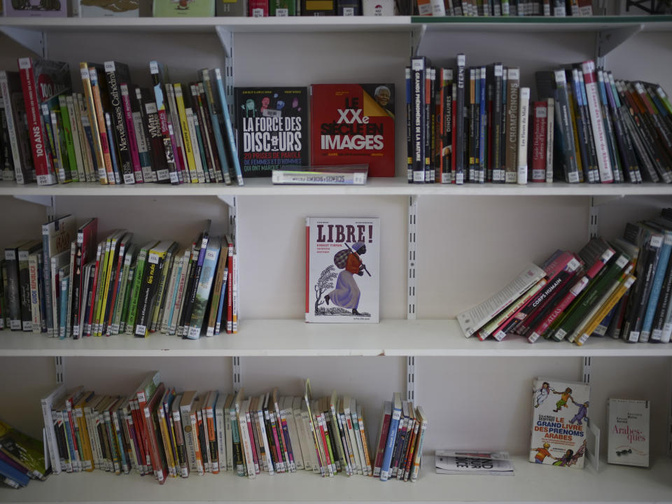 Books, including one on Harriet Tubman, are displayed in the library at Ibn Khaldoun, a private Muslim school, in Marseille, southern France, Tuesday, April 16, 2024. (AP Photo/Daniel Cole)