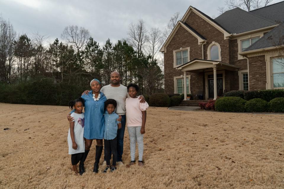 Dana Evans, 43, poses for a portrait with her husband and children at her family's home