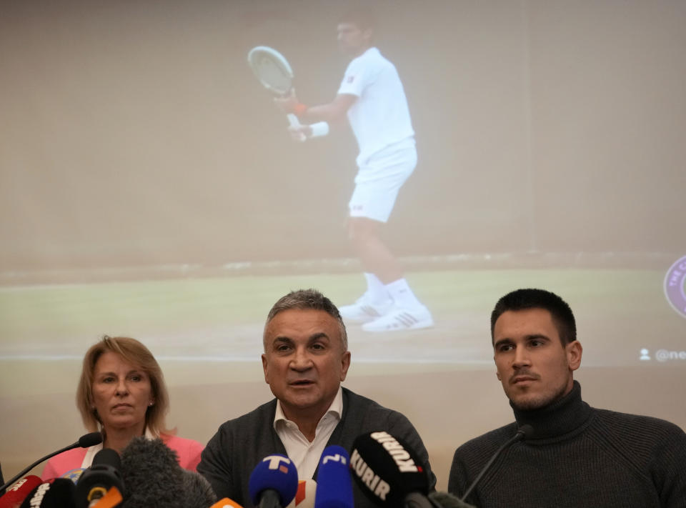 Serbia's Novak Djokovic's father Srdjan, center, brother Djordje, right, and mother Dijana attend a press conference in Belgrade, Serbia, Monday, Jan. 10, 2022. Tennis star Novak Djokovic on Monday won a court battle to stay in Australia to contest the Australian Open despite being unvaccinated against COVID-19, but the government threatened to cancel his visa a second time. Federal Circuit Court Judge Anthony Kelly reinstated Djokovic's visa, which was canceled after his arrival last week because officials decided he didn't meet the criteria for an exemption to an entry requirement that all non-citizens be fully vaccinated. (AP Photo/Darko Vojinovic)