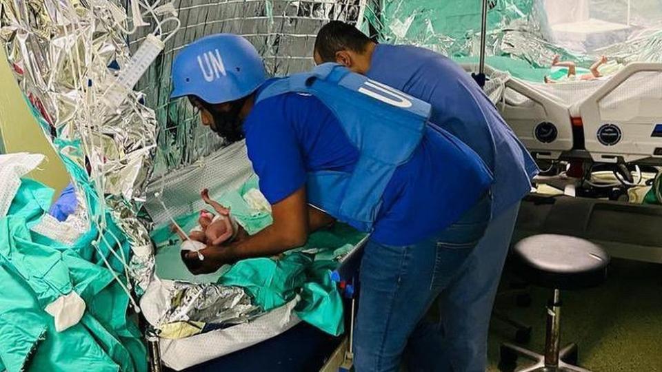 United Nations personnel caring for one of the babies