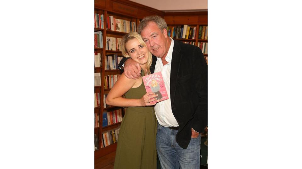 Jeremy Clarkson wrapping his arm around Emily Clarkson inside a bookstore