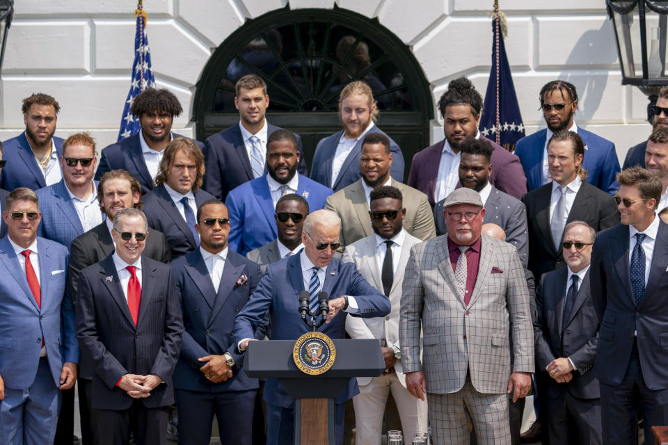 President Joe Biden, surrounded by members of the Tampa Bay Buccaneers, speaks during a ceremony on the South Lawn of the White House in Washington, Tuesday, July 20, 2021, where the president honored the Super Bowl Champion Tampa Bay Buccaneers for their Super Bowl LV victory. Tampa Bay Buccaneers Quarterback Tom Brady at right. (AP Photo/Andrew Harnik)