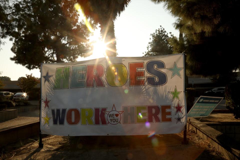 A sign in front of Kingston Healthcare Center in Bakersfield reads "Heroes work here."