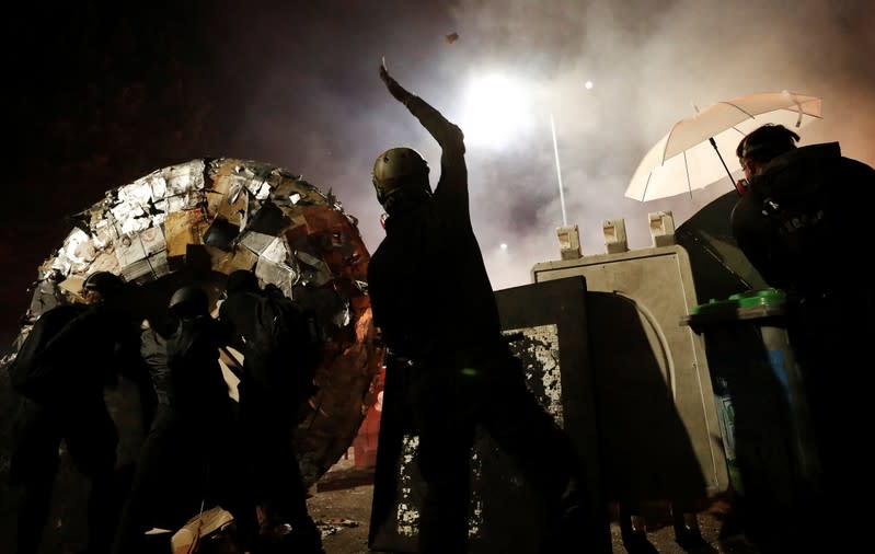 A protesters throws a molotov cocktail during a standoff with riot police at the Chinese University of Hong Kong