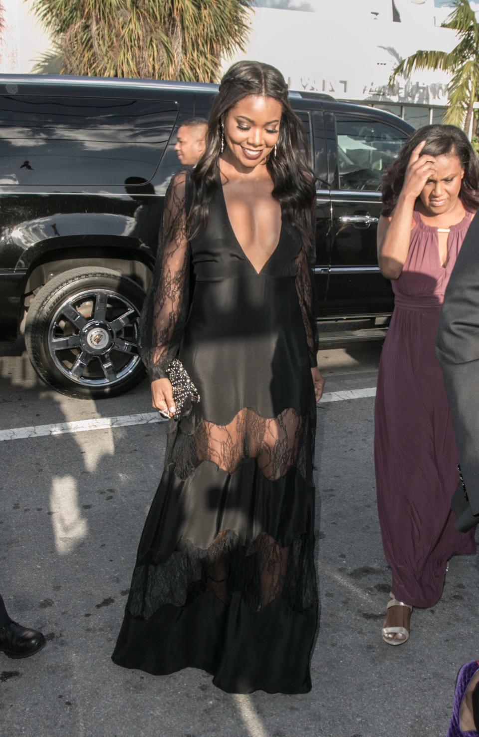 Gabrielle Union walks in a black dress.