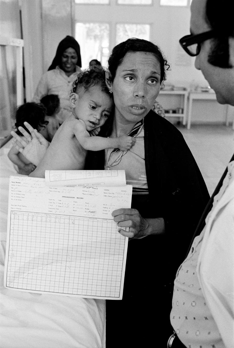 In this 1975 photo from the U.N. Relief and Works Agency, UNRWA, archive, Fathiyeh Sattari, a worried Palestinian mother talks to a doctor about her underweight child, Hassan, who is being treated at a Rafah health center run by the U.N. Relief and Works Agency, UNRWA. The photo is part of UNWRA's vast photo archive being digitized in Gaza and Denmark to preserve a record of one of the world's most entrenched refugee problems, created in what the Palestinians call the "Nakba," or “catastrophe”-- their uprooting in the war over Israel's 1948 creation. (AP Photo/G.Nehmeh, UNRWA Photo Archives)