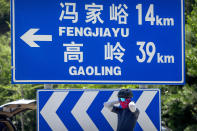 A member of the Qiyi bicycle club takes a break along a highway during a group ride through the Baihe River Canyon in the northern outskirts of Beijing, Wednesday, July 13, 2022. Cycling has gained increasing popularity in China as a sport. A coronavirus outbreak that shut down indoor sports facilities in Beijing earlier this year encouraged people to try outdoor sports including cycling. (AP Photo/Mark Schiefelbein)