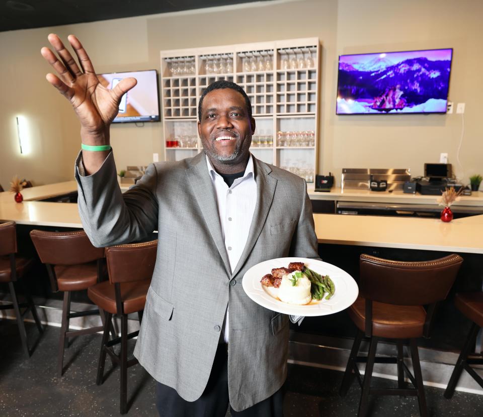 Sunrise Steakhouse owner Ruben Pierre shows off a dish at the new restaurant on Centre Street in Brockton on Thursday, Feb. 8, 2024. The restaurant offers a "fusion of Haitian flavors and cuisine with a mixture of the traditional American fine dining steakhouse," he said.
