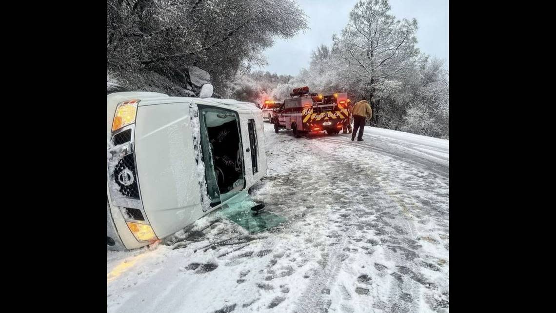Emergency personnel attend to a crash in Fresno County near Auberry and Powerhouse roads on a snowy Wednesday, March 1, 2023, according to the California Highway Patrol.