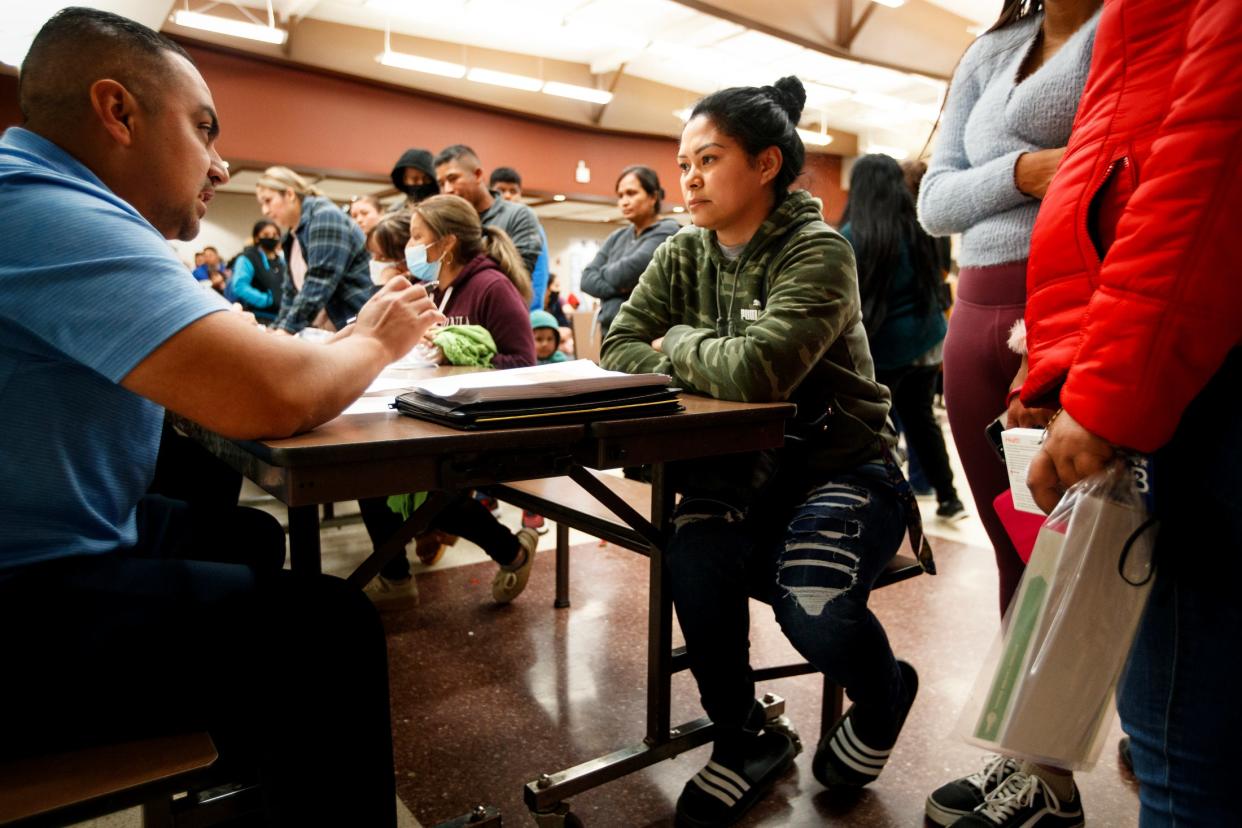 Juan Garcia, left, a Riverside County development manager, provides information to Gladys Barnachia during an Oasis Mobile Home Park community update meeting at Oasis Elementary School on Feb. 1.