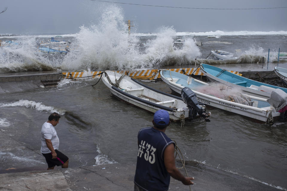 Fishermen remove their boats from the dock in the Veracruz state of Mexico, Friday, Aug. 20, 2021. Residents began making preparations for the arrival of Tropical Storm Grace. (AP Photo/Felix Marquez)