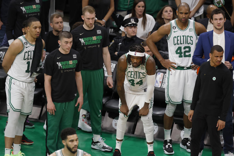 Boston Celtics center Robert Williams III (44), center Al Horford (42) and other teammates react during the second half of Game 2 of the NBA basketball playoffs Eastern Conference finals against the Miami Heat in Boston, Friday, May 19, 2023. (AP Photo/Michael Dwyer)