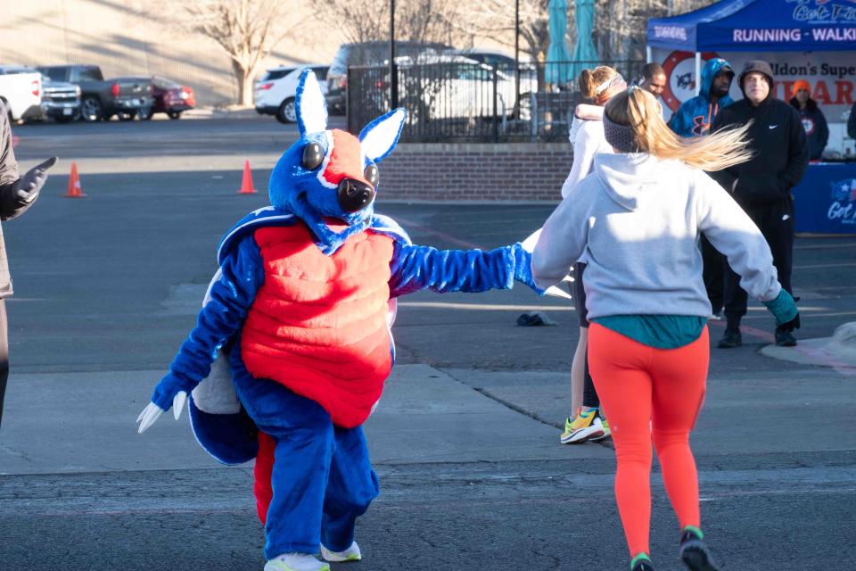 Get Fit's mascot Shelden greets a finisher Saturday at the Cold As Ice run in Amarillo.