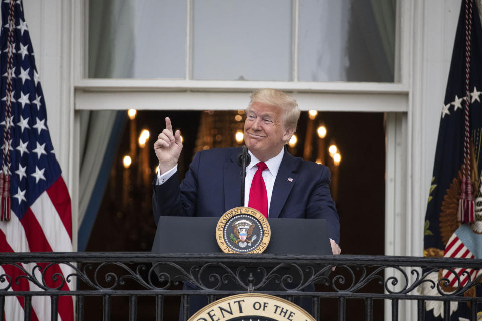 President Donald Trump gestures while speaking during a "Rolling to Remember Ceremony," to honor the nation's veterans and POW/MIA, from the Blue Room Balcony of the White House, Friday, May 22, 2020, in Washington. (AP Photo/Alex Brandon)