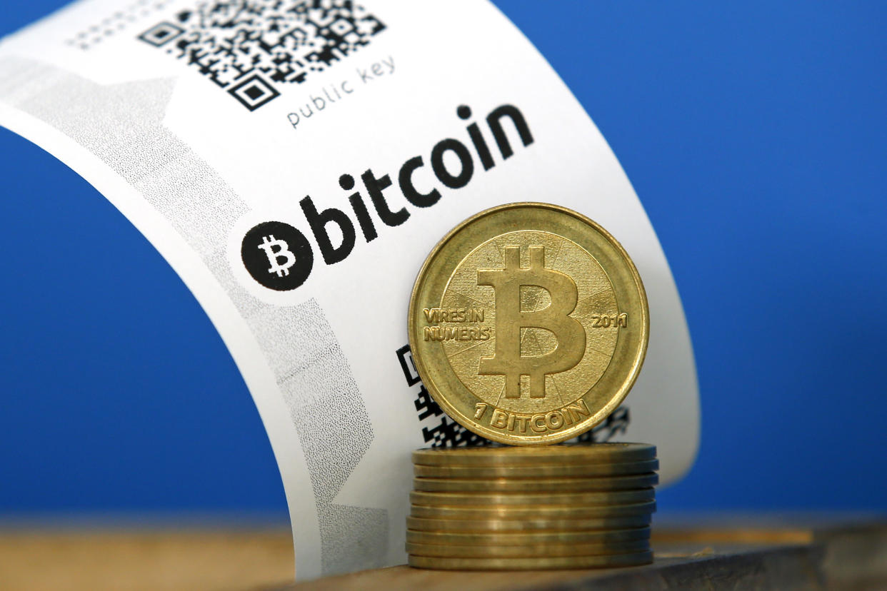 A Bitcoin (virtual currency) paper wallet with QR codes and coins are seen in an illustration picture taken at La Maison du Bitcoin in Paris July 11, 2014. French police dismantled an illegal Bitcoin exchange and seized 388 virtual currency units worth some 200,000 euros ($272,800) in the first such operation in Europe a public prosecutor said on Monday.   REUTERS/Benoit Tessier (FRANCE - Tags: BUSINESS)