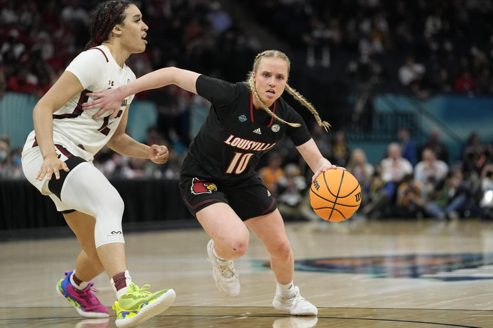 FILE - Louisville's Hailey Van Lith drives past South Carolina's Brea Beal during the first half of a college basketball game in the semifinal round of the Women's Final Four NCAA tournament Friday, April 1, 2022, in Minneapolis. The Cardinals will pursue their first tournament title since 2018 with three of their top six scorers back including junior guard Hailey Van Lith. (AP Photo/Eric Gay, File)
