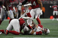 FILE - Arizona Cardinals quarterback Josh Rosen (3) is sacked by Atlanta Falcons defensive end Bruce Irvin (52) during the second half of an NFL football game, Sunday, Dec. 16, 2018, in Atlanta. Several teams were forced quickly back on the quarterback draft carousel with eight instances of a team using another first-round pick on a quarterback in the ensuing four drafts, including the Cardinals, who traded away Rosen after one year and took Kyler Murray first overall in 2019. (AP Photo/Danny Karnik, File)