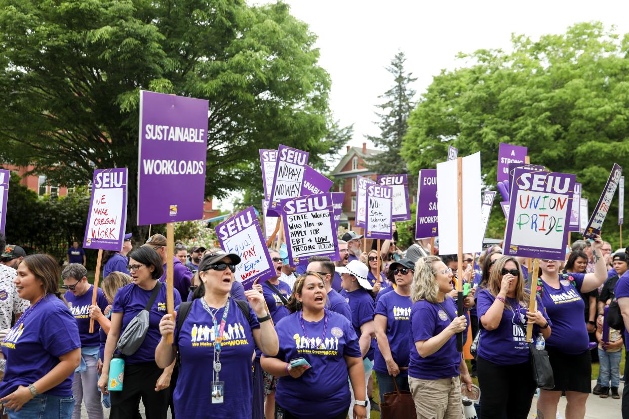 More than 1,000 state of Oregon workers from various agencies rally June 8 in Salem for a union contract. They carried signs telling their stories.