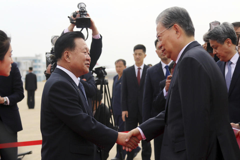 Choe Ryong Hae, left, vice-chairman of the central committee of the Workers' Party of North Korea, shakes hands with Zhao Leji, chairman of the National People’s Congress of China and considered the No. 3 official in the ruling Communist Party, as Zhao and other delegates arrive at the Pyongyang International Airport in Pyongyang, North Korea, Thursday, April 11, 2024. (AP Photo/Cha Song Ho)