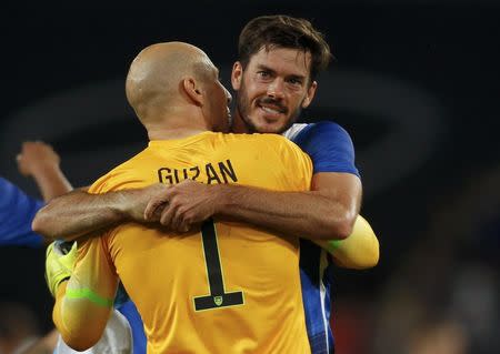 Brad Guzan of the U.S. embraces his team mate Brad Evans (R) after winning their international friendly soccer match against Germany in Cologne, Germany June 10, 2015. REUTERS/Ina Fassbender