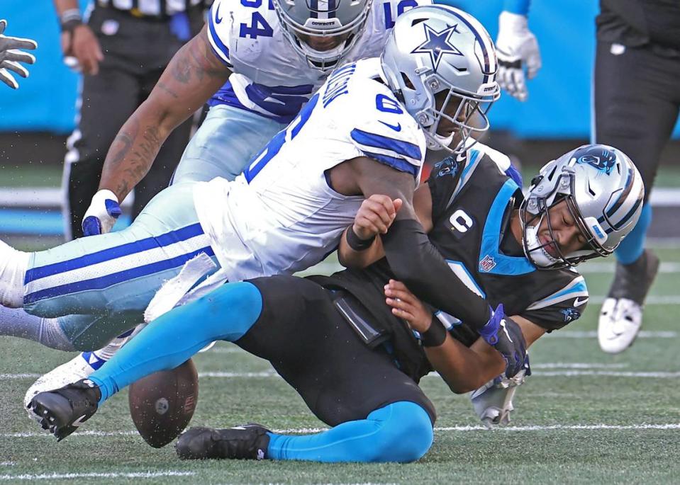 Carolina Panthers quarterback Bryce Young fumbles the ball while being sacked by Dallas Cowboys safety Donovan Wilson during second half action at Bank of America Stadium in Charlotte, NC on Sunday, November 19, 2023. The Cowboys defeated the Panthers 33-10.