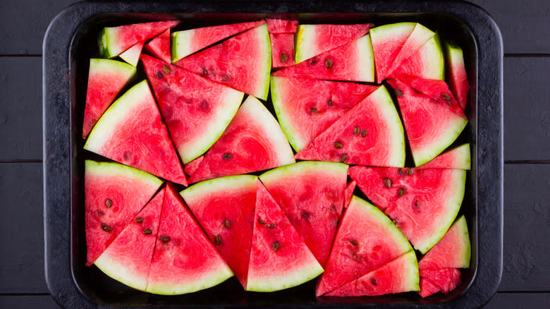 watermelon slices in black tray