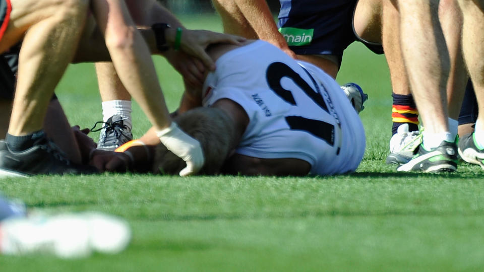 ADELAIDE, AUSTRALIA – MAY 16: Nick Riewoldt of the Saints is attended by staff after an injury during the round seven AFL match between the Adelaide Crows and the St Kilda Saints at Adelaide Oval on May 16, 2015 in Adelaide, Australia. (Photo by David Mariuz/Getty Images)