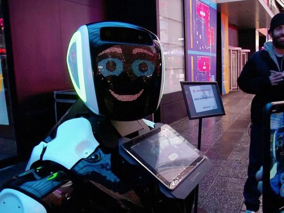 Passers-by in Times Square interact with a Promobot robot that informs the public about the symptoms of coronavirus and how to prevent it from spreading, in this still frame obtained from video, in New York City, U.S.  February 10, 2020. REUTERS/Reuters TV