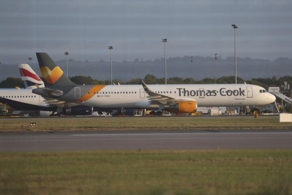 A Thomas Cook plane on the tarmac at Gatwick Airport in Sussex, England Monday Sept. 23, 2019. British tour company Thomas Cook collapsed early Monday after failing to secure emergency funding, leaving tens of thousands of vacationers stranded abroad. (Steve Parsons/PA via AP)