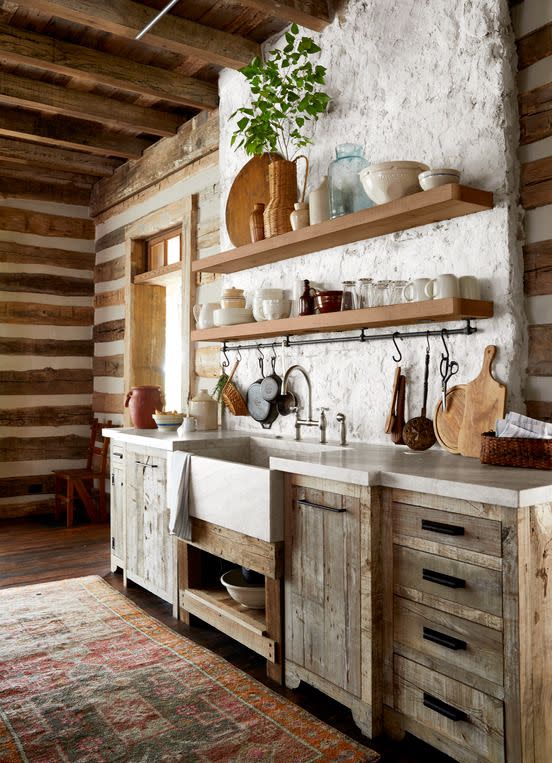 concrete countertops site atop reclaimed wood cabinetry in a mountain house