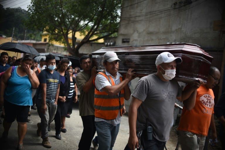 Relatives carry the coffin of a victim of a landslide, to the municipal cemetery in Santa Catarina Pinula, some 15 km east of Guatemala City, on October 3, 2015