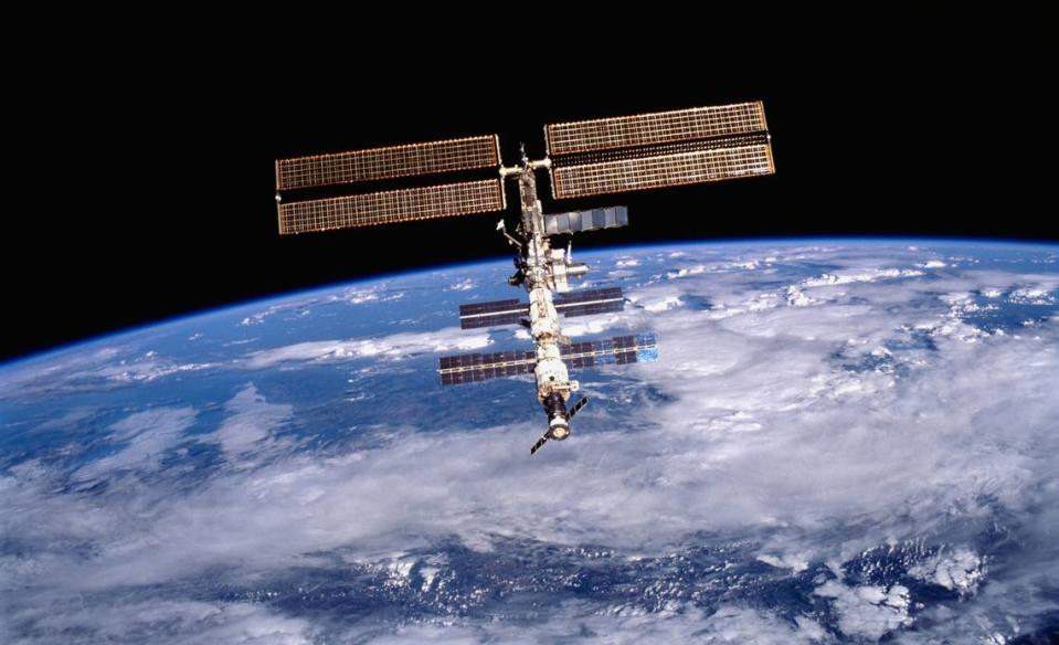 The International Space Station in orbit above Earth. This image of the International Space Station (ISS) was photographed by one of the crewmembers of the STS-105 mission from the Shuttle Orbiter Discovery after separating from the ISS.