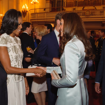 Kate Middleton outdone by Michelle Obama  She could have made a grand splash at the London Games' Opening Ceremony. Instead, the Duchess of Cambridge toned it down with an icy blue Christopher Kane coat-dress. (At least she wore a British designer!) First Lady Michelle Obama outshone Kate at a cocktail reception in Buckingham Palace in a white flowing gown by J. Mendel accentuated by silver embroidery. Regardless who you think won the style-off, both women look very chic. (Photo by Dominic Lipinski - WPA Pool/Getty Images)