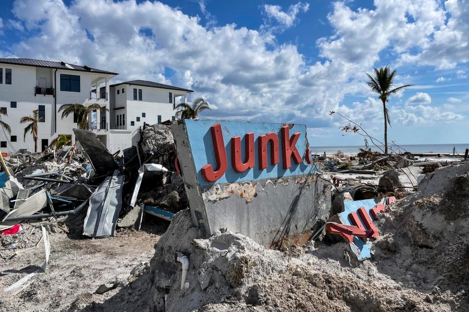 The damaged sign for the Junkanoo Beach eatery on Fort Myers Beach, Fla. on Tuesday, October 11, 2022, nearly two weeks after Hurricane Ian. 